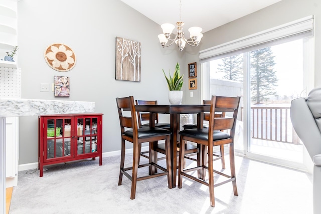 dining room featuring baseboards, light colored carpet, lofted ceiling, and a chandelier