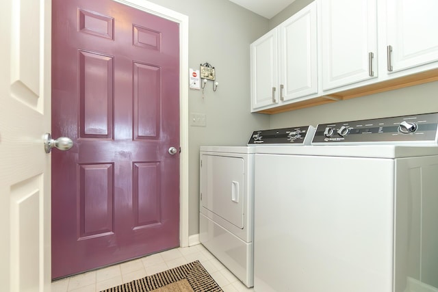 laundry area with light tile patterned floors, cabinet space, and independent washer and dryer