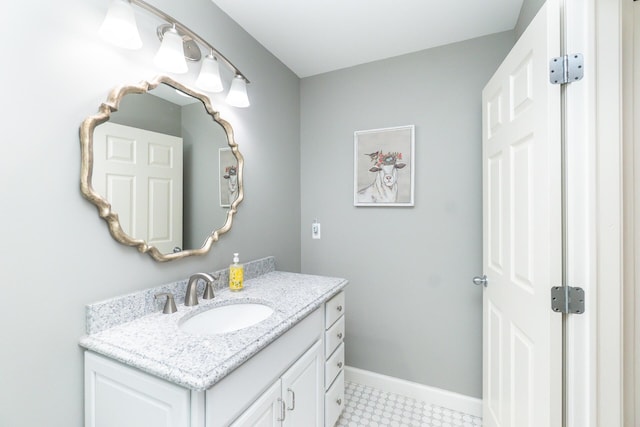 bathroom with vanity and baseboards