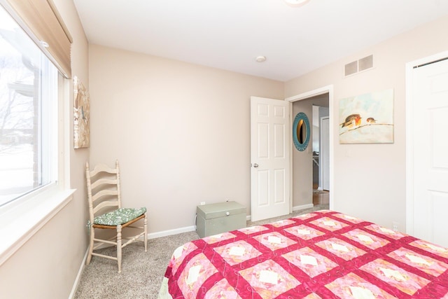 carpeted bedroom featuring baseboards and visible vents