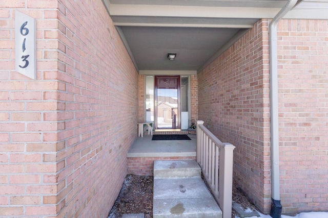 view of exterior entry with brick siding