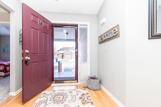 entrance foyer featuring light wood-type flooring and baseboards