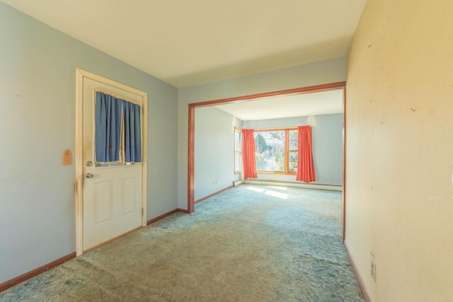 carpeted empty room with baseboards