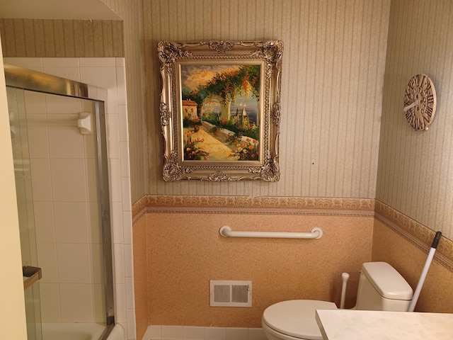 bathroom with visible vents, wallpapered walls, toilet, wainscoting, and vanity