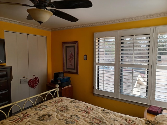 bedroom with a closet, multiple windows, and a ceiling fan