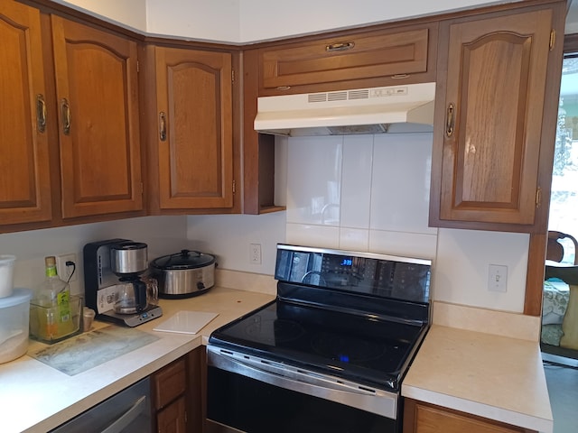 kitchen with electric range, light countertops, under cabinet range hood, dishwasher, and brown cabinets