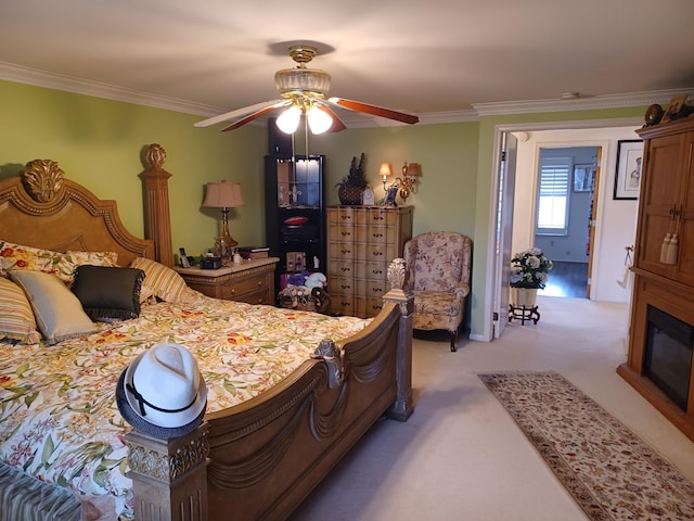 bedroom featuring light carpet, crown molding, and ceiling fan