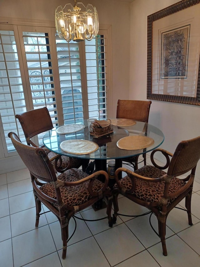 dining room featuring tile patterned floors and an inviting chandelier