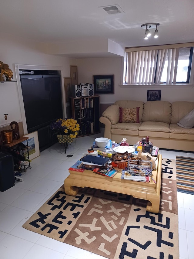 tiled living room featuring visible vents