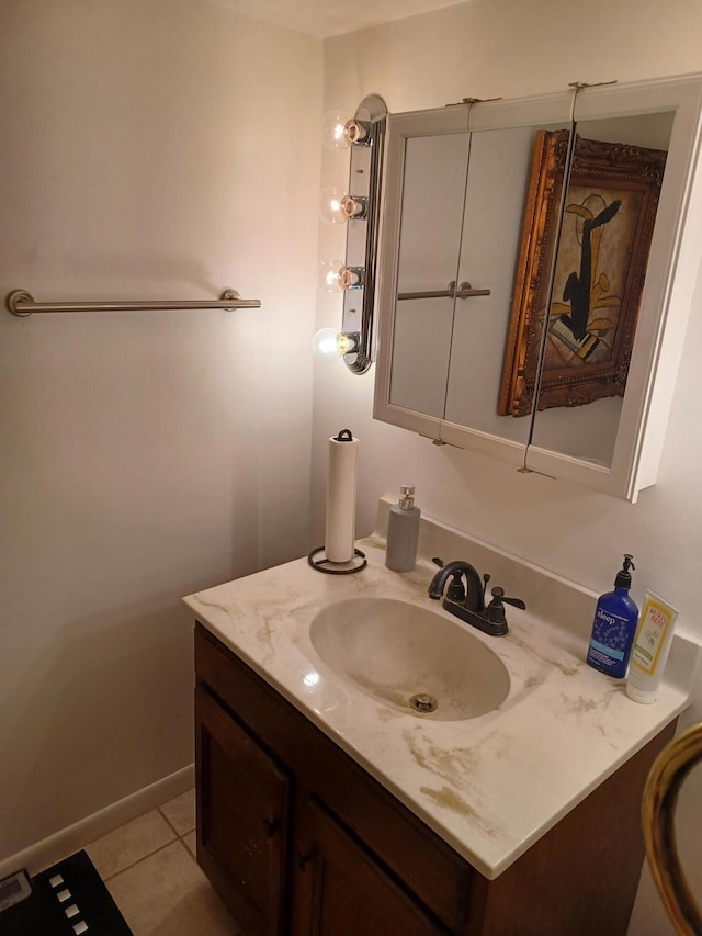 bathroom featuring vanity, tile patterned floors, and baseboards