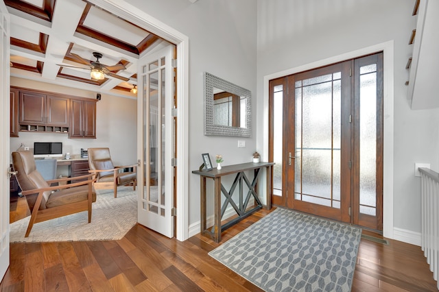 entrance foyer with ceiling fan, dark wood finished floors, beam ceiling, baseboards, and coffered ceiling