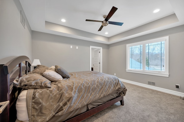 bedroom with visible vents, carpet floors, baseboards, recessed lighting, and a tray ceiling