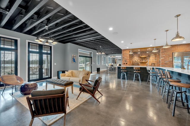 living area with recessed lighting and concrete floors