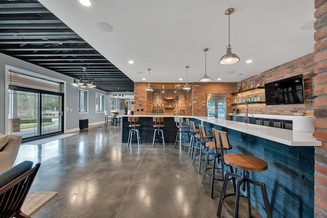 bar with brick wall, decorative light fixtures, baseboards, concrete floors, and recessed lighting