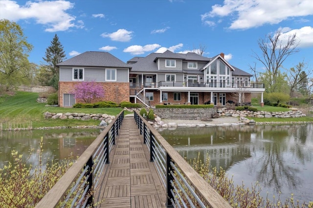 dock area featuring a lawn and a water view