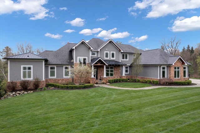 craftsman-style house featuring a standing seam roof, metal roof, brick siding, and a front yard