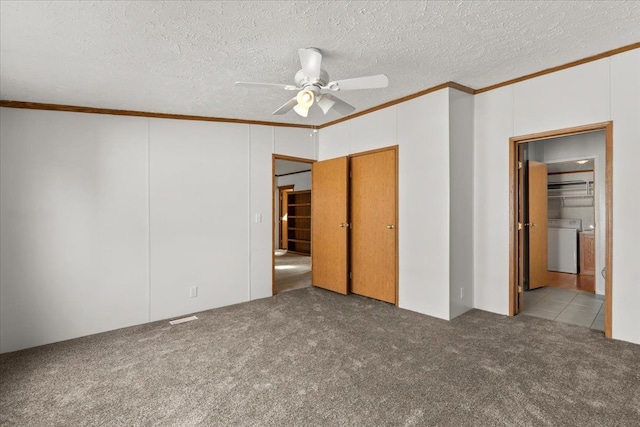 unfurnished bedroom with ceiling fan, carpet floors, a textured ceiling, and ornamental molding