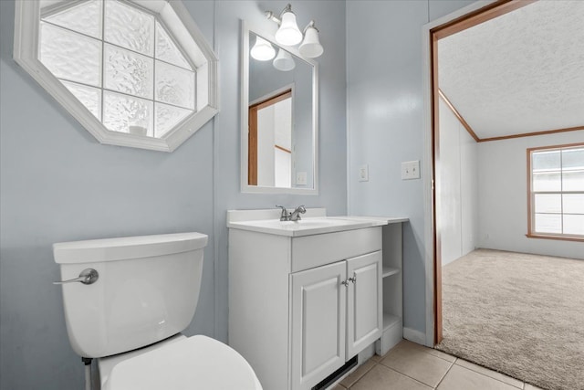 bathroom featuring toilet, a textured ceiling, crown molding, tile patterned flooring, and vanity