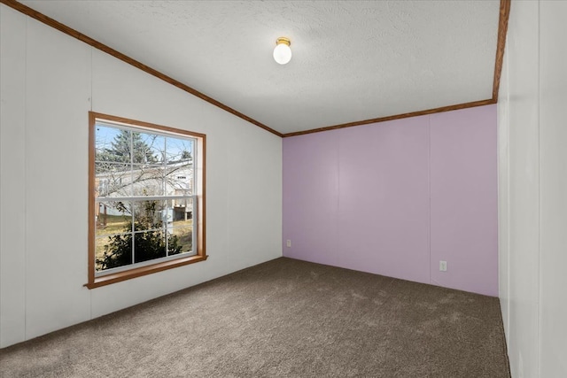 carpeted spare room with a textured ceiling, crown molding, and vaulted ceiling