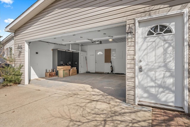 garage featuring concrete driveway and a garage door opener