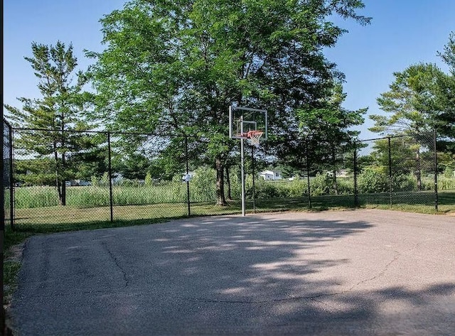 view of basketball court with community basketball court and fence