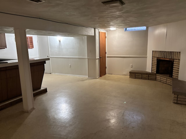 finished basement featuring a fireplace