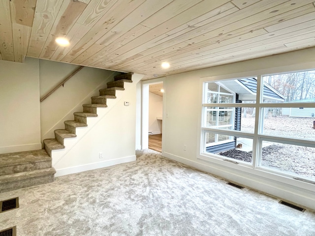 interior space featuring visible vents, carpet floors, wooden ceiling, and stairway