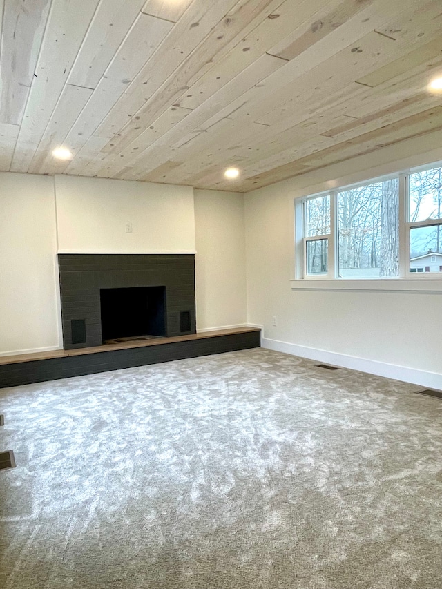 below grade area with a wealth of natural light, visible vents, baseboards, and wooden ceiling