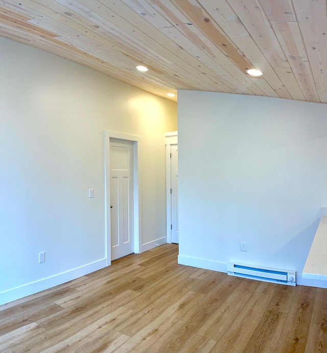 spare room with light wood-type flooring, a baseboard heating unit, baseboards, and wooden ceiling