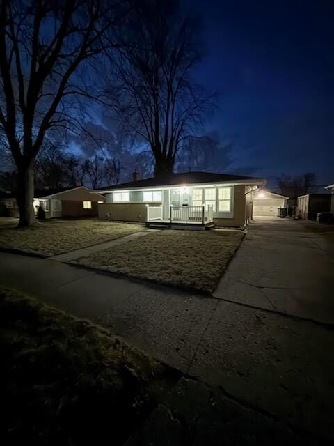 single story home with concrete driveway