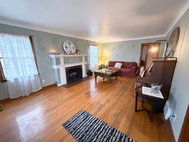 2126 Pierce St, Flint, MI 48503 - living area with a fireplace with flush hearth and light wood-style flooring