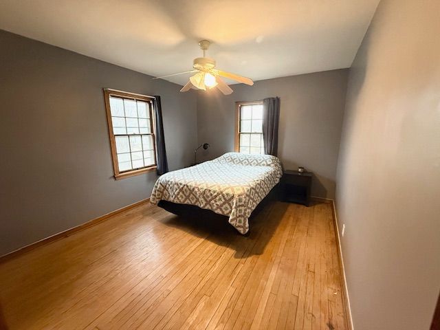 2126 Pierce St, Flint, MI 48503 - bedroom with a ceiling fan, baseboards, and light wood finished floors
