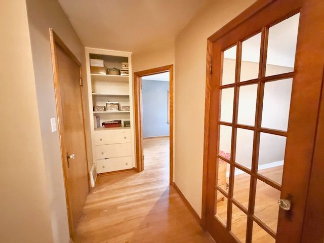 2126 Pierce St, Flint, MI 48503 - hall with baseboards, light wood-style flooring, and built in features