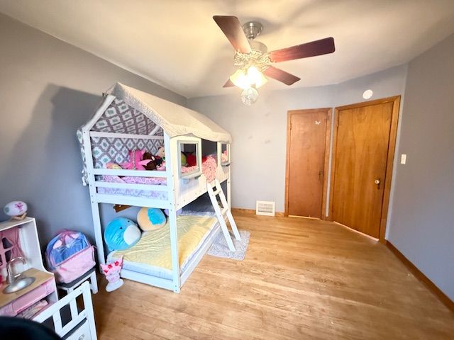 2126 Pierce St, Flint, MI 48503 - bedroom with visible vents, baseboards, ceiling fan, and light wood-type flooring
