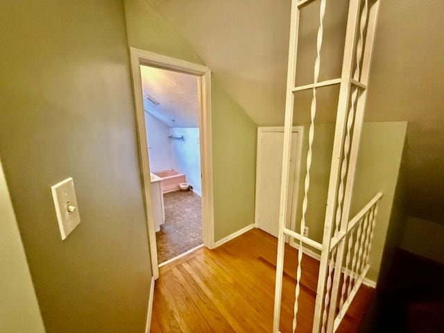 2126 Pierce St, Flint, MI 48503 - hallway with baseboards, lofted ceiling, and wood finished floors
