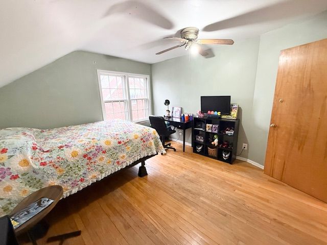 2126 Pierce St, Flint, MI 48503 - bedroom with baseboards, a ceiling fan, wood finished floors, and lofted ceiling