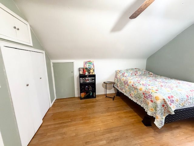 2126 Pierce St, Flint, MI 48503 - bedroom with a closet, light wood-style flooring, ceiling fan, and vaulted ceiling