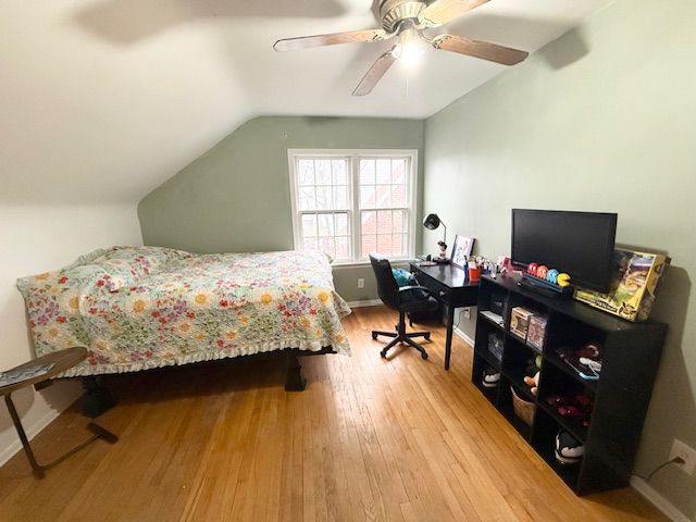 2126 Pierce St, Flint, MI 48503 - bedroom featuring baseboards, ceiling fan, vaulted ceiling, and wood finished floors