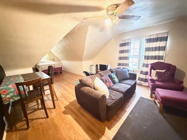 2126 Pierce St, Flint, MI 48503 - living room featuring a ceiling fan, wood finished floors, and vaulted ceiling