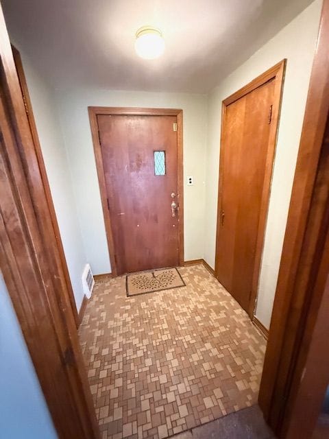 2126 Pierce St, Flint, MI 48503 - doorway to outside featuring visible vents