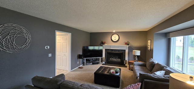 carpeted living room featuring a fireplace with flush hearth, a textured ceiling, and baseboards