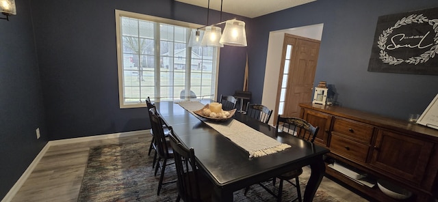 dining area featuring baseboards and wood finished floors