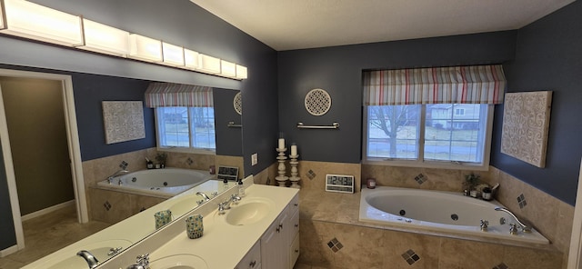 full bath featuring a sink, double vanity, and a whirlpool tub