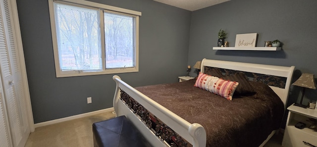 carpeted bedroom with baseboards