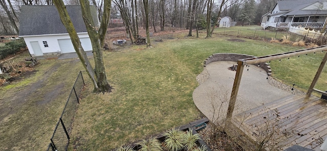 view of yard with an outbuilding, a garage, and fence