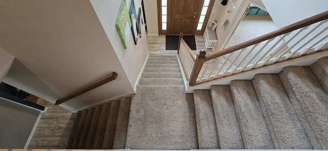 staircase featuring carpet flooring