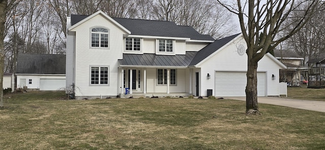 traditional-style house with a standing seam roof, metal roof, concrete driveway, a front yard, and a garage