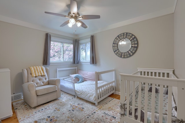 bedroom with wood finished floors, baseboards, and ceiling fan