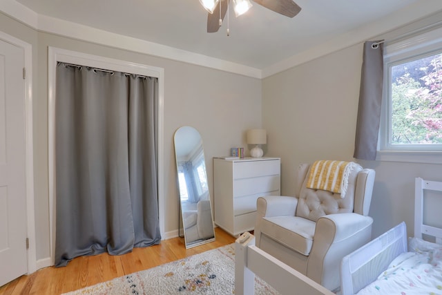 sitting room featuring a ceiling fan and light wood-style flooring