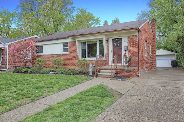 view of front of house featuring brick siding, a chimney, an outbuilding, and a front yard